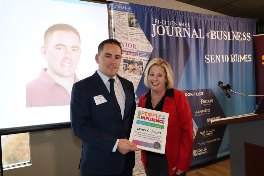 Two people on stage with an award.