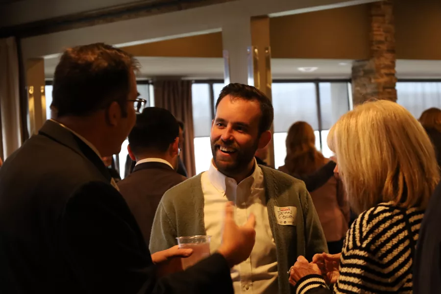 A group of three people talking.