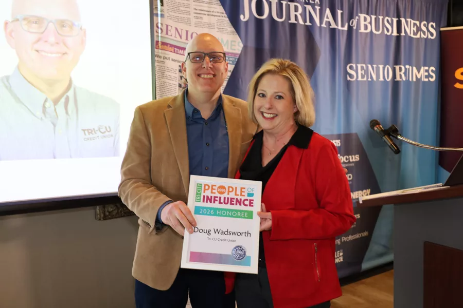 Two people on stage with an award.