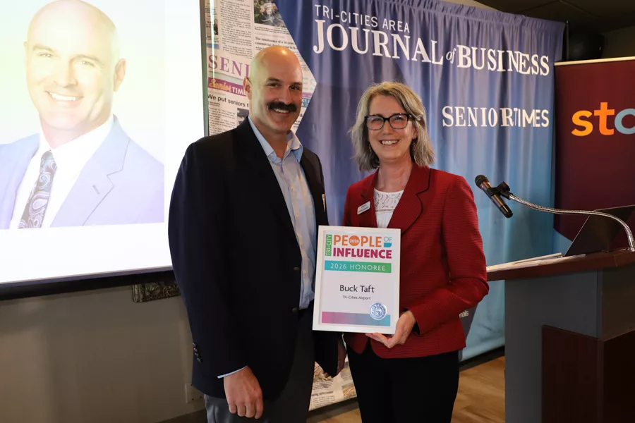 Two people on stage with an award.