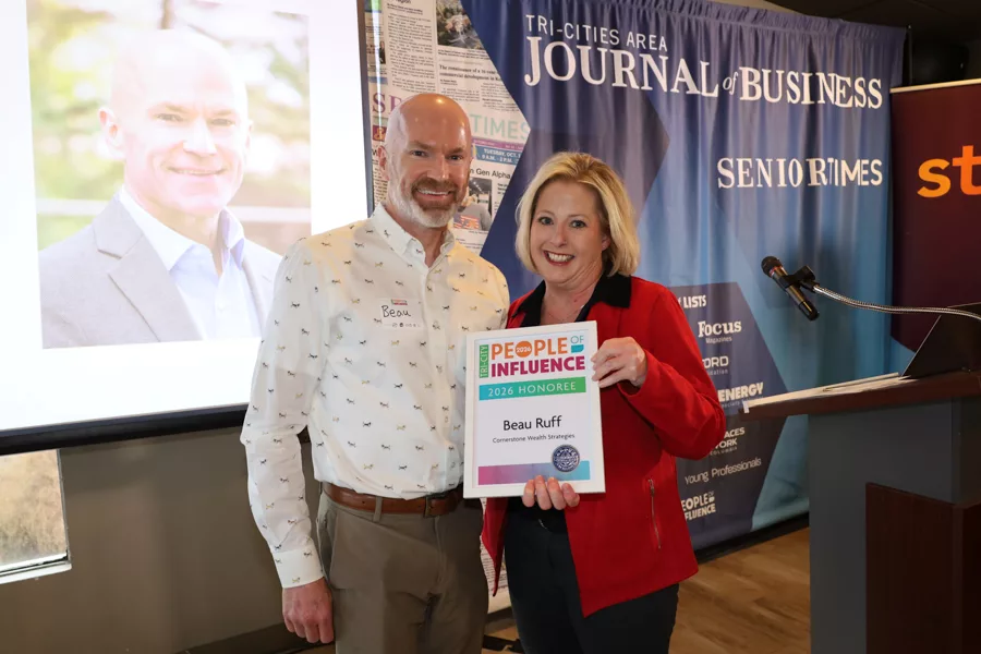 Two people on stage with an award.
