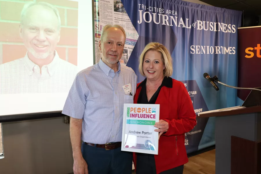 Two people on stage with an award.