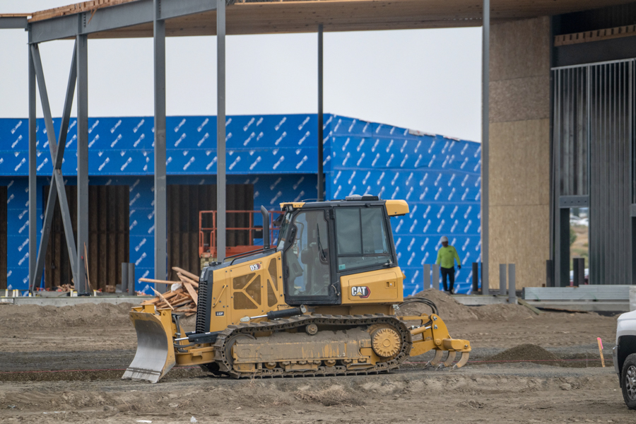 A bulldozer near a construction site.