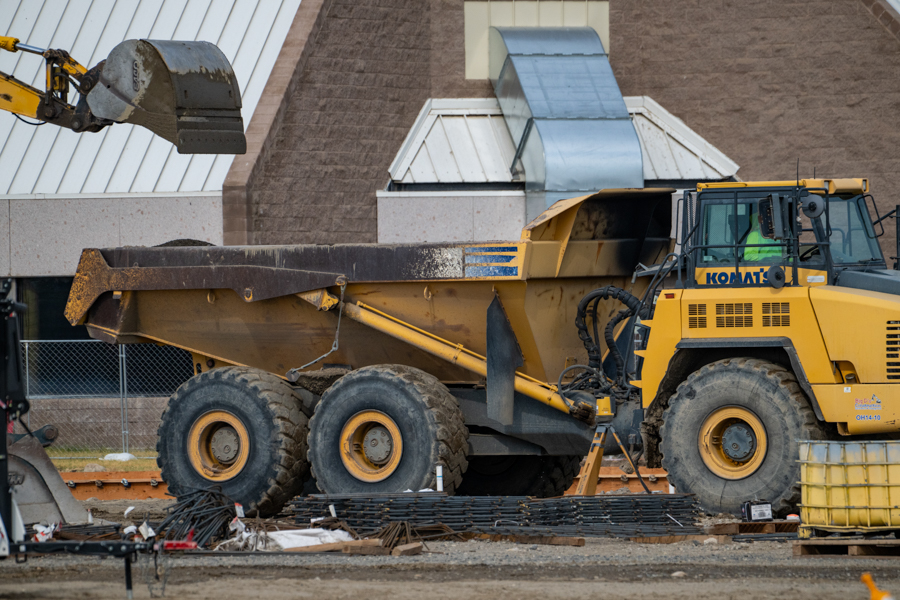 An excavator and a dump truck.