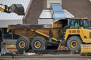 An excavator and a dump truck.