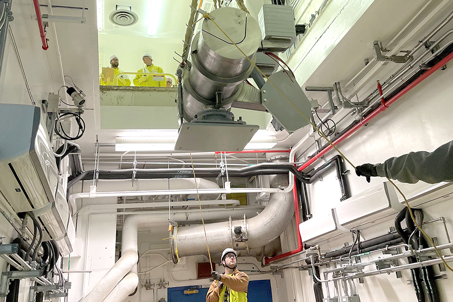 A critical piece of capsule transfer equipment is lifted into the Waste En - capsulation and Storage Facility