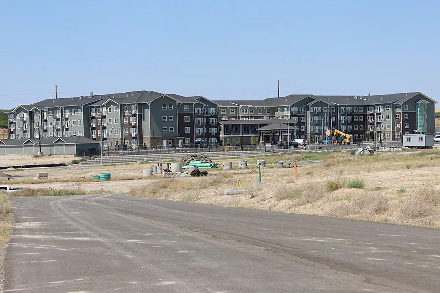 Large apartment-like buildings in a field.