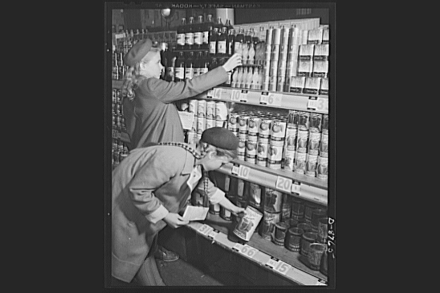 An old photo of girls interacting with store shelves.