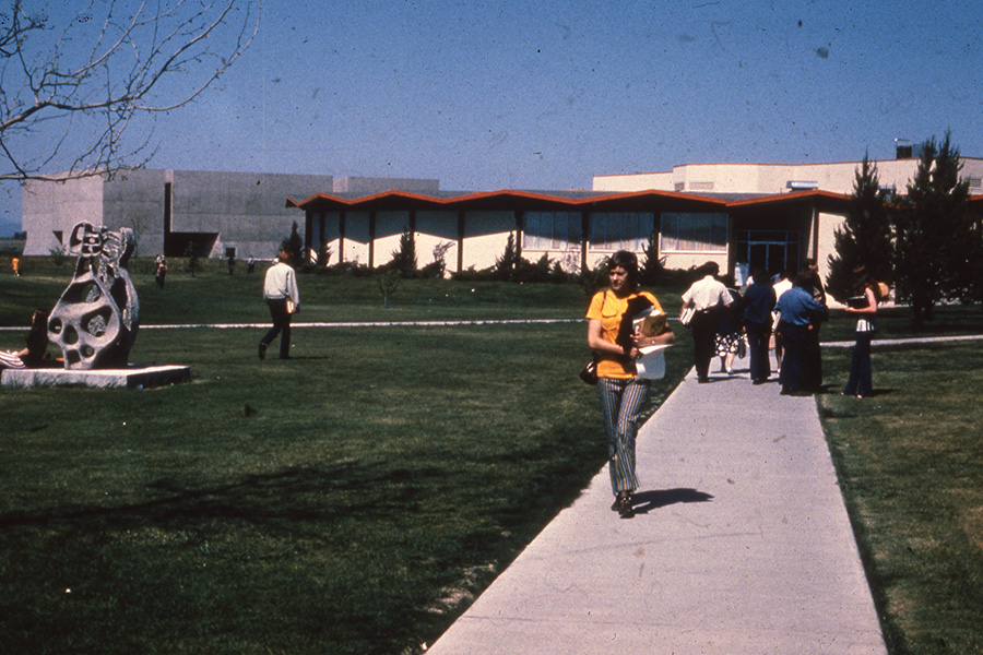 An old photo of the CBC campus with students walking about.