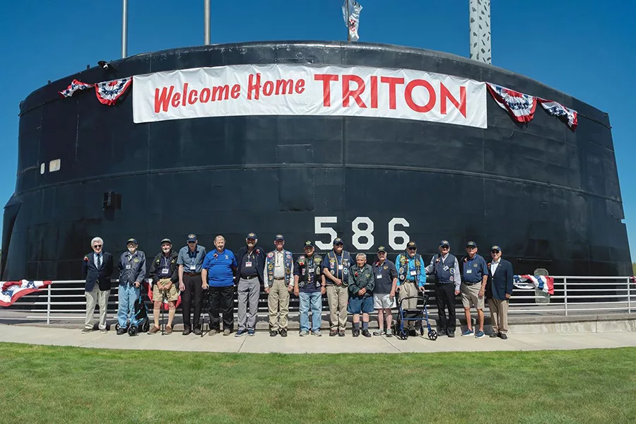 The Triton submarine with a sign that says, "Welcome Home Triton."