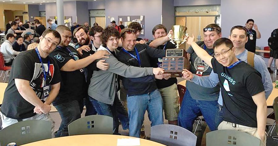 Adam Cabrey, John Joseph Jr., Stephen Erlenbush, Phillip Todd, Levi Staley, Keith Thornhill, Warren Fogg and Matt Hodge pull on the regional trophy, while the guys who attacked the Cyber Hawks' database during the competition tug back in jest.  