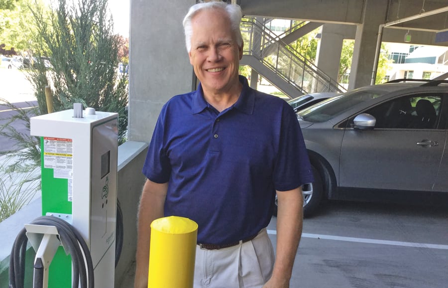 Jeff Clark, Vice President of Support Services for Kadlec Regional Medical Center, stands next to one of the electric car-charging stations offered at Kadlec's new five-story parking garage. Charging is free.