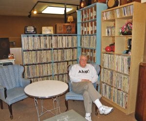 Gale Metcalf, secretary for the East Benton County Historical Society, sits in the radio lounge at the Kennewick museum. KONA radio donated the vinyl collection to the museum, which visitors can listen to when they visit. The redesigned museum re-opens Saturday, March 4 after being closed for a month.