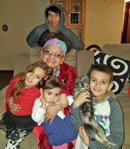 Perla Zepeda’s youngest children, Avarie, Alicia, and Aden, who is holding the Yorkshire Chihuahua puppy named Joaquin, pose with their grandmother and older brother Jacob.