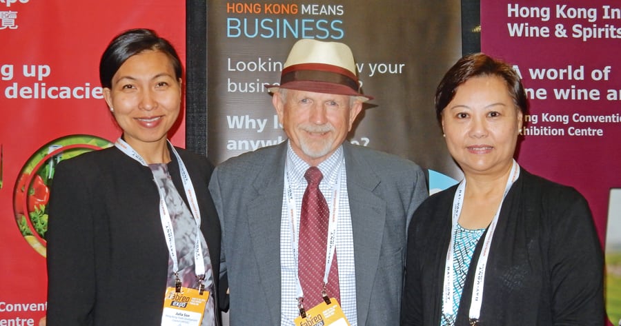 TRIDEC’s Gary A. White, center, stands with Julia Son, left, and Teresa Hung, right, from the Hong Kong Trade Development Council at the 2016 FABREO Expo. (Courtesy TRIDEC)