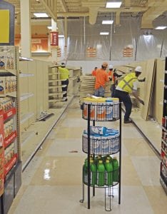 Workers remove shelving in the Richland Fred Meyer as part of the store’s six-month remodeling project. Store officials say the process is a bit like working on a big jigsaw puzzle.