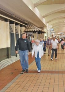 Patsy Hull, 89, walks around the perimeter of Columbia Center mall in Kennewick with her son, Mickey Hull of Hermiston, on May 15. Seven people, including Hull, have reached the 15,000-mile mark or higher in the Kadlec Healthy Ages mall walkers program.