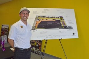 Ty Franzen, general manager of Planet Fitness, stands in front of the Kennewick gym’s floor plan. The gym is scheduled to open this month.