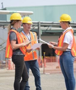 Katie Henckel, right, environmental permitting engineer with the Bechtel Environmental Safety & Health department, discusses Hanford’s vitrification plant features with summer interns Maggie Schappell and Nathan Sargent. (Courtesy Bechtel National)