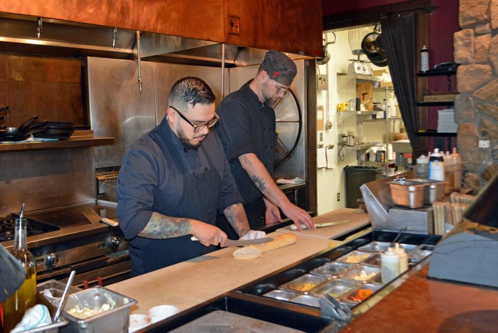 Steven Carbajo, lead line cook, left, and Paul Westover, sous chef, prep for the dinner rush at Taverna Tagaris in Richland. Westover said only 15 percent of those who applied for their recent job posting for a line cook were qualified. Columbia Basin College will launch a hospitality program this winter to provide job training for the growing restaurant and hotel industry.
