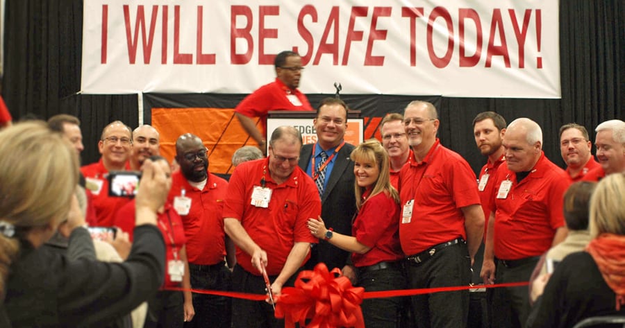 Bruce Loflin, manager of the new Pasco AutoZone Distribution Center, cuts the ribbon at the Nov. 4 grand opening ceremony with Pasco Mayor Matt Watkins and AutoZone corporate executives looking on.