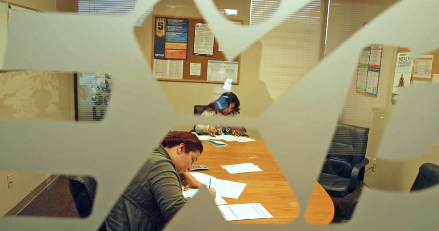 Eager job seekers fill out basic paperwork at Express Employment Professionals in Kennewick, where hiring specialists meet with clients and place them in positions throughout the area.