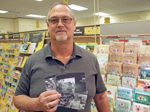 Owner Patrick Jilek holds old photographs from when his parents owned Crest Hallmark Shops in the Tri-Cities. The Kennewick Plaza store will close in January. Jilek plans to keep the remaining Richland store open on George Washington Way.