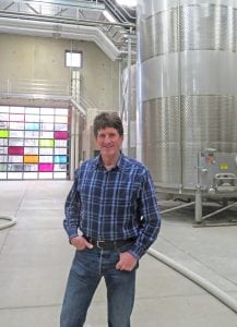 David Forsyth, winemaker and general manager of Four Feathers Wine Estates in Prosser, stands in the 50,000-square-foot warehouse that produces bulk wines.