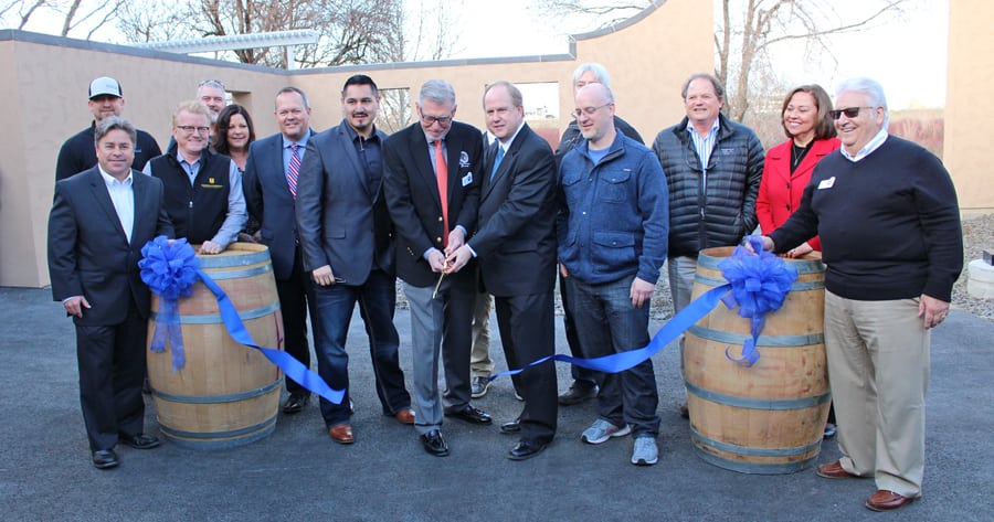 Sharing the golden scissors to cut the ribbon during the Feb. 9 ground-breaking of Columbia Gardens Urban Wine & Artisan Village are Don Barnes, vice president of the Port of Kennewick Commission, left, and Kennewick Mayor Don Britain. Winemaker Victor Palencia of Palencia Wine Company stands next to Barnes and Bart Fawbush of Bartholomew Winery is next to Britain. (Courtesy Port of Kennewick)
