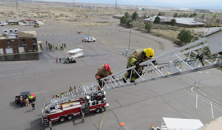 Melanie Hair, general manager and founder of the Tri-Cities Area Journal of Business and Senior Times, climbs the aerial ladder March 23 at the HAMMER Federal Training Facility in Richland. She was participating in Fire Ops 101 training to learn what it's like to be a firefighter.