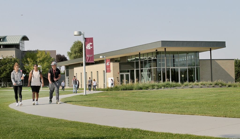 Students stroll past the new Student Union Building on the campus of Washington State University Tri-Cities in Richland. The $5.73 million building, completed this year, is used for student leisure, study, meetings and events. (Photo: Paul T. Erickson)