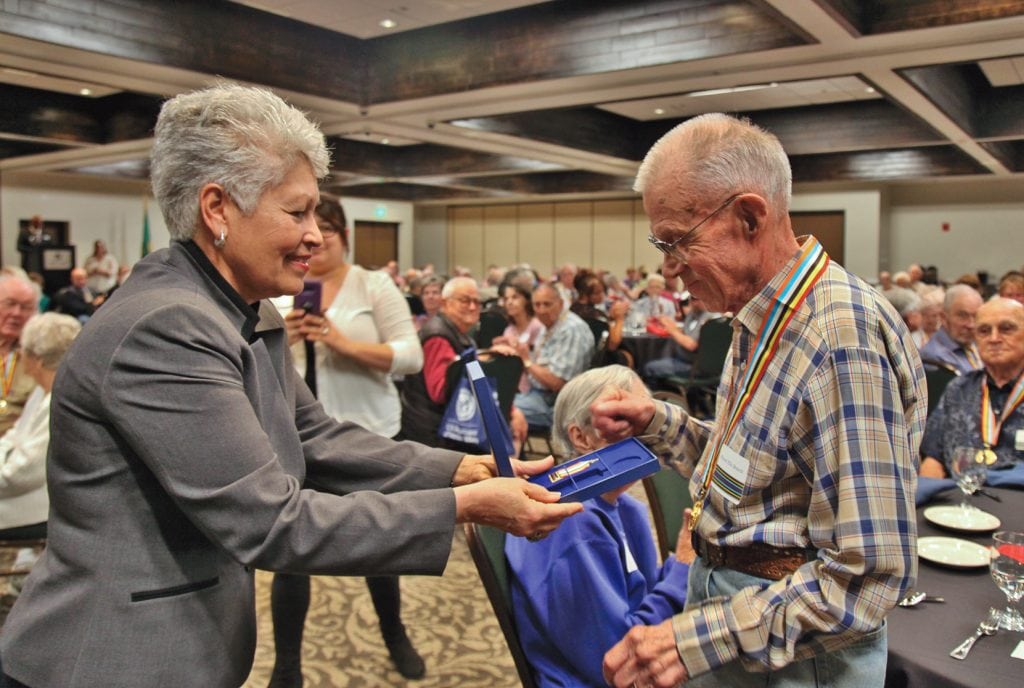 Richard Brandt, 88, an Army veteran who lives in Richland, receives the Ambassador for Peace Medal during a June 8 ceremony in Kennewick from Alfie Alvarado-Ramos, director of the Washington Department of Veterans Affairs. (Courtesy Washington Department of Veterans Affairs)