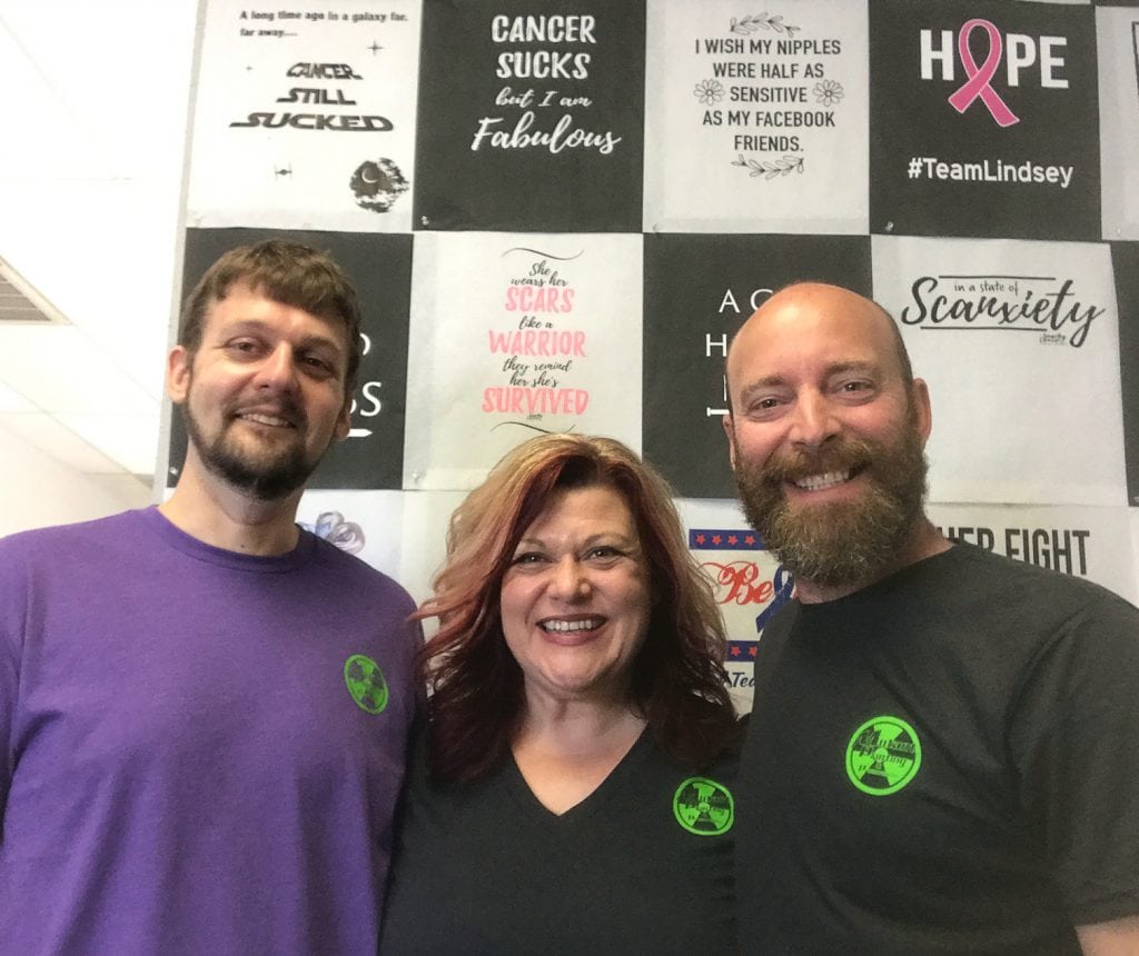 Tre Shelly, from left, Trishia Shelly-Stephens and Mike Stephens have opened Mutant Printing & Promotions and Snarky Cancer in Kennewick as a family affair. Mike and Tre do the screen printing, while Trishia does the business management and marketing. (Courtesy Snarky Cancer)