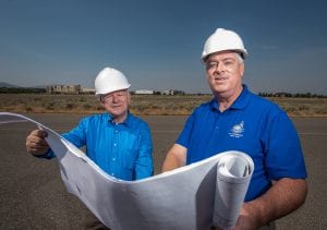 Thomas Moak, president of the Port of Kennewick’s board of commissioners, left, and Larry Peterson, the port’s director of planning and development, pose with the plans for the Vista Field development at the site of the former Kennewick airport. The port plans to redevelop the 103-acre site into an urban, mixed-use, pedestrian-focused area. (Photo: Scott Butner Photography)