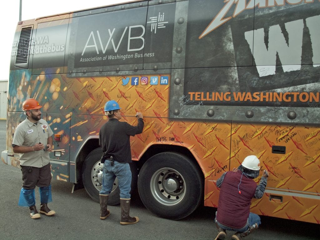 Tyson Fresh Meats employees sign Association of Washington Business’ custom wrapped bus as an act of solidarity with other manufacturing workers across the state. Despite growth in other areas, manufacturing employment has been on the decline for the past decade in Washington.