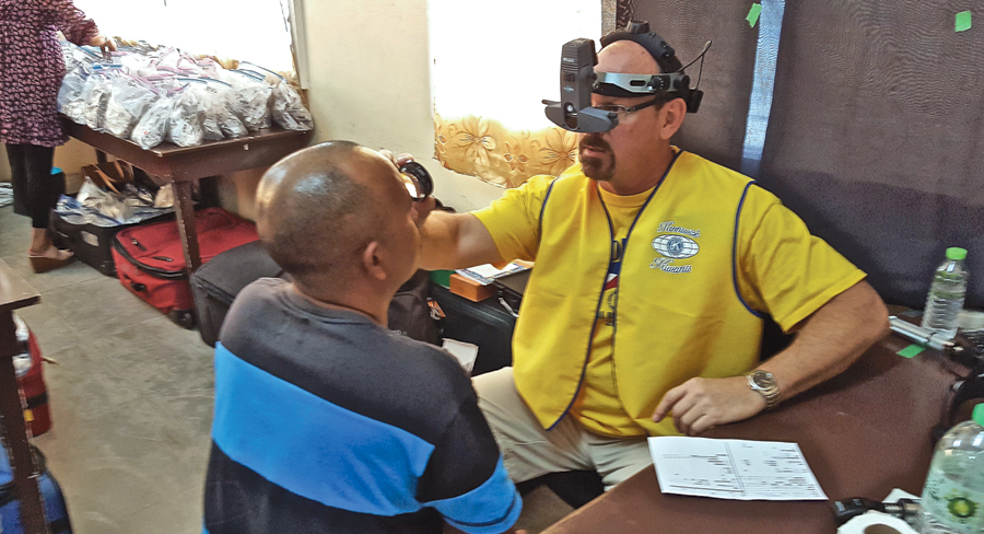 Dr. Cory Manley traveled to the Philippines and used a bio-microscope to look at the back of patients’ eyes in January 2018. When he retires Dec. 18, he plans to travel to more countries to help people without access to vision care. (Courtesy Dr. Cory Manley)