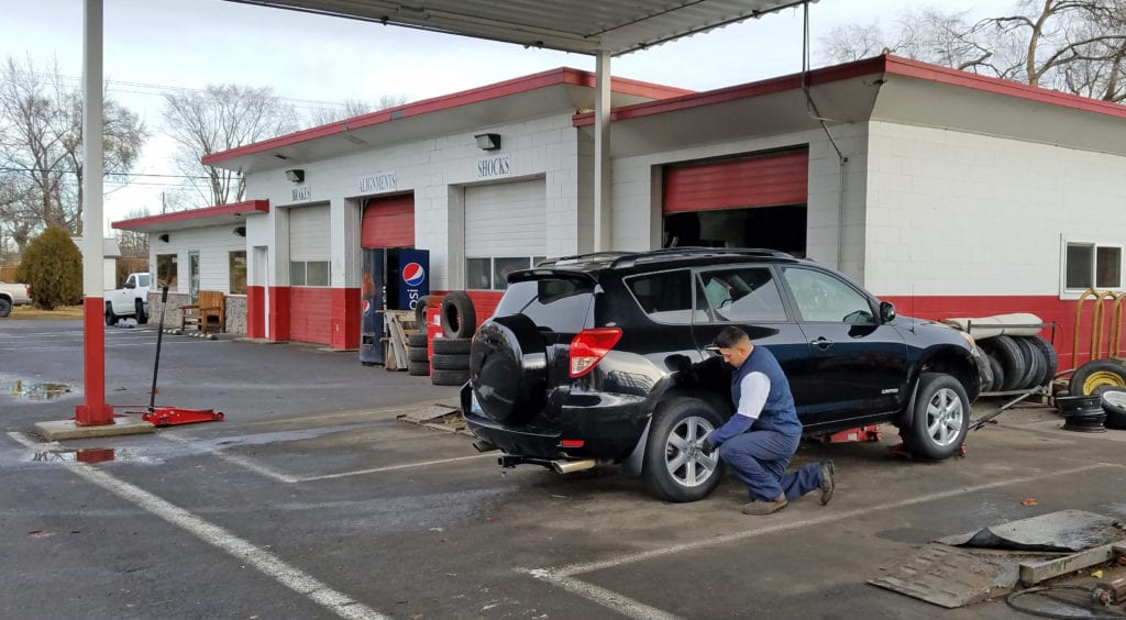 Tire Technician Gumaro Cruz adds air to a customer’s tires at the Benton City Tire Center. 