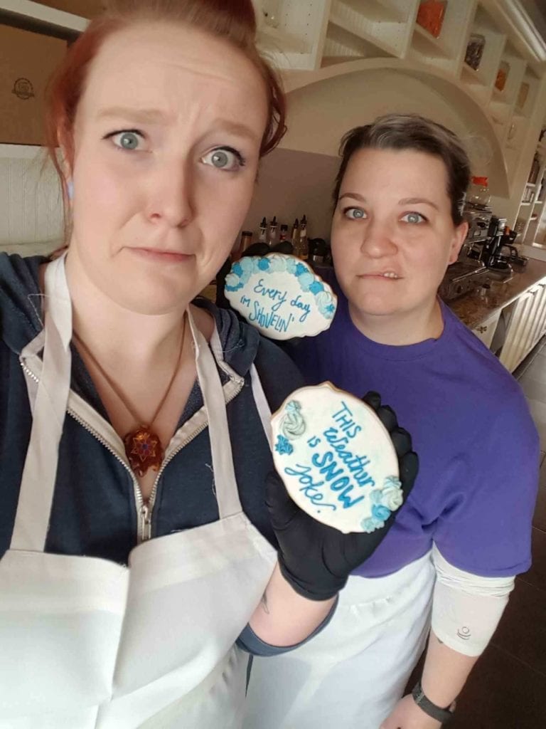 Tsp Bakeshop’s Jacee Jamison, head baker, left, and Melissa Nissen, owner, decided to channel their winter weather angst into cookies decorated with snow puns. The West Richland bakery is at 4850 Paradise Way, Suite 202, adjacent to Yoke’s Fresh Market. (Courtesy Tsp Bake Shop)
