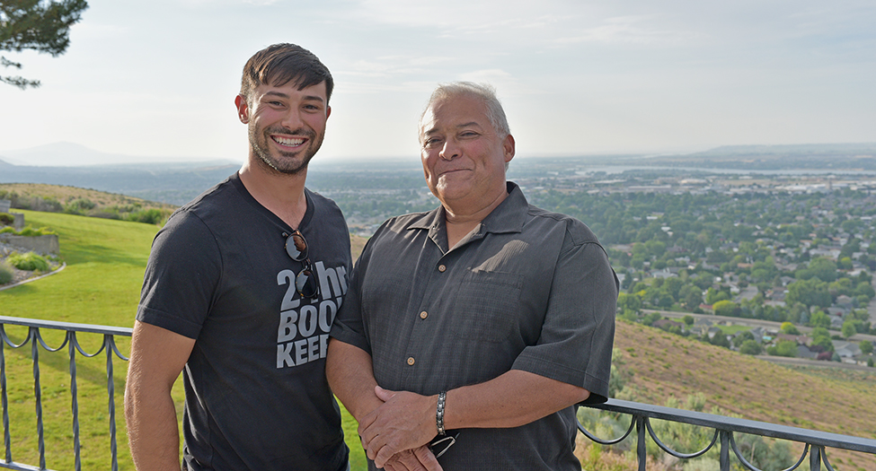 Jordan Chavallo stands with his father Jose on their home’s deck overlooking Kennewick’s Vista Field in the distance. The Chavallo family’s business, New Environment Corp., plans to build luxury apartments on 8.25 acres adjacent adjacent to Vista Field, where construction is underway to turn the former airfield into a pedestrian-focused urban center.