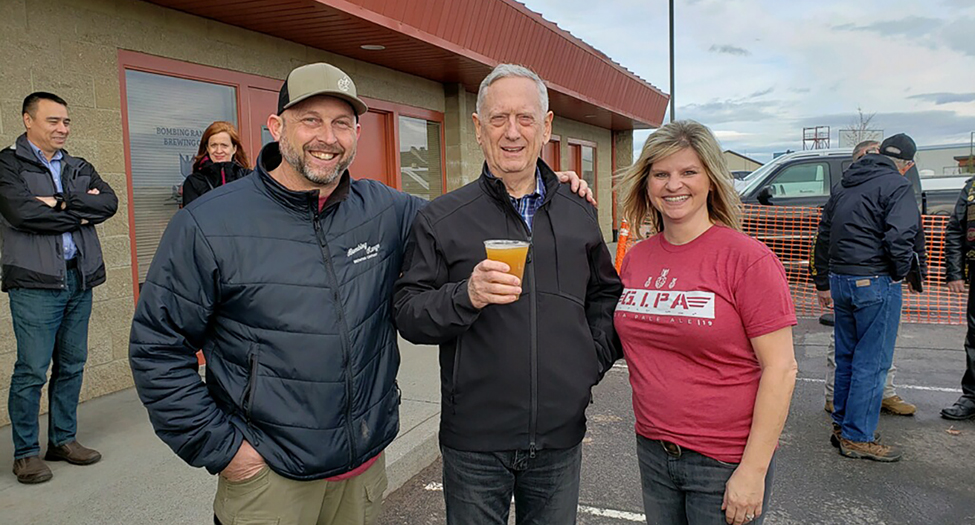 Bombing Range Brewing Co. has established a following that includes famous people, like former Secretary of Defense James Mattis, center, standing between brewery owners Mike and Dashia Hopp. The Hopps plan to open a second bar called The Dive in the same north Richland building in June. (Courtesy Dashia Hopp)