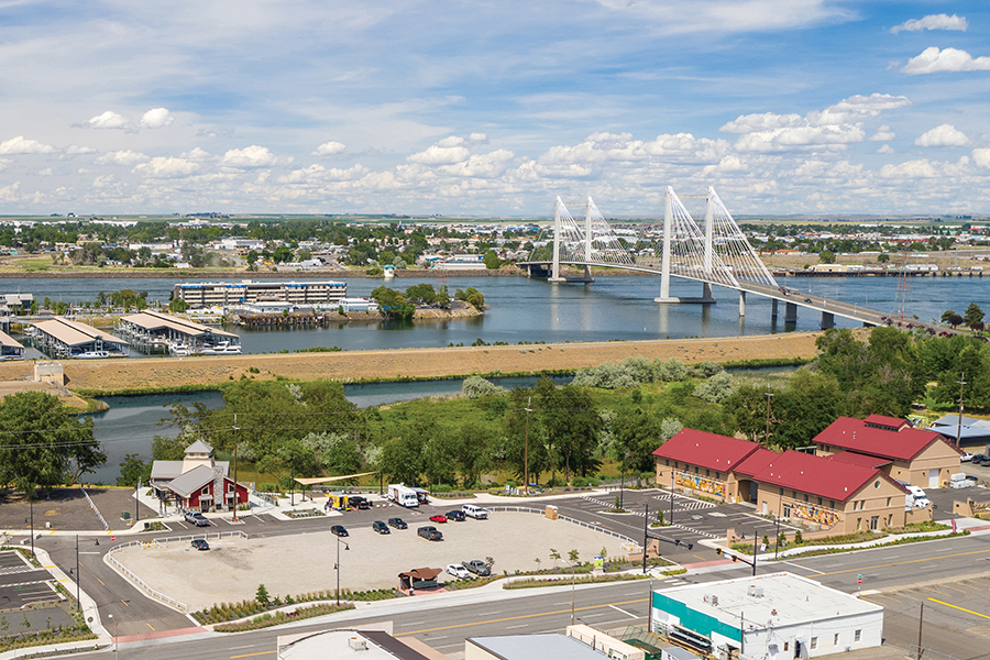The Port of Kennewick’s Columbia Gardens Urban Wine & Artisan Village and Clover Island are visible in the foreground. 
The Pasco shoreline is visible across the Columbia River in the background. (Courtesy PS Media/Port of Kennewick)
