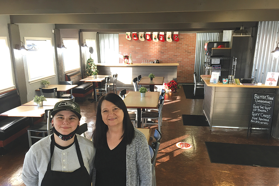 The mother-daughter team of Niki Young, left, and Mary Sue Hui stand in the dining room of their newly renovated restaurant Pacific Pasta & Grill at 603 Goethals Drive in Richland. They briefly removed their masks to be photographed. (Photo by Kristina Lord)