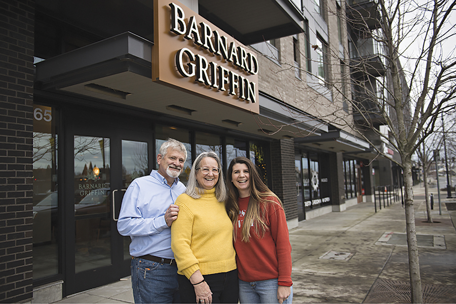 Rob Griffin, from left, and his wife, Deborah Barnard, pause for a portrait with their daughter, Megan Hughes, outside the new Barnard Griffin tasting room at The Waterfront in Vancouver. (Courtesy Amanda Cowan/The Columbian)