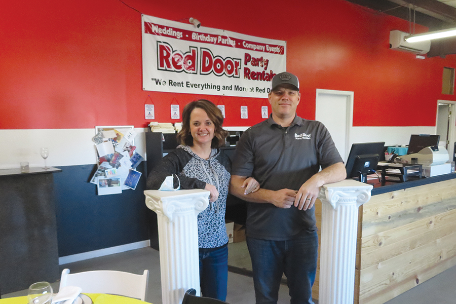 Red Door Party Rentals owners Tammy and P.J. Stoflet stand in the lobby at their Richland store at 1331 Wyman Road. The couple have owned the business for 14 years but haven’t ever experienced a year like the past one. (Photo by Kristina Lord)