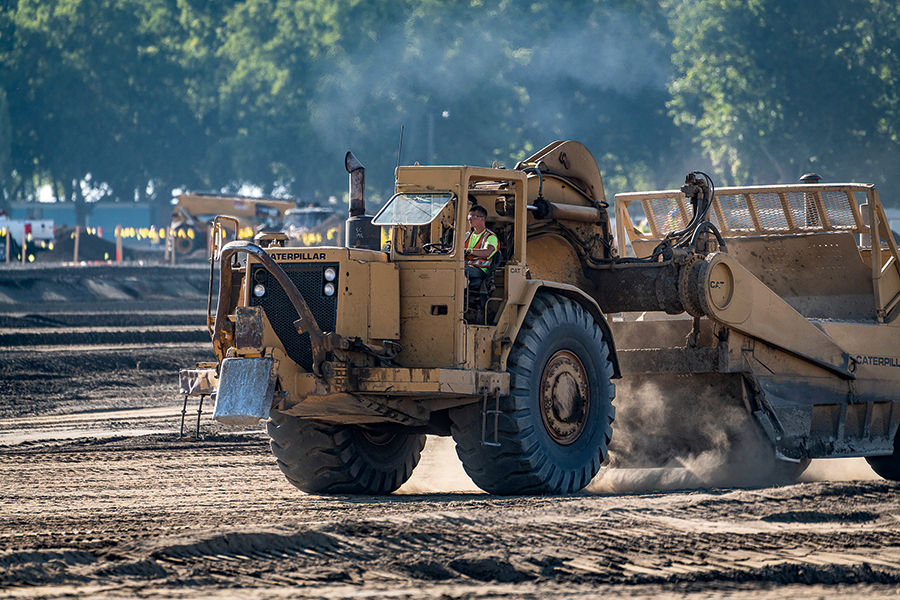 Earth moving equipment prepares the site of one of the two Amazon distribution centers being built along South Road 40 East in Pasco. (Photo by Scott Butner Photography)