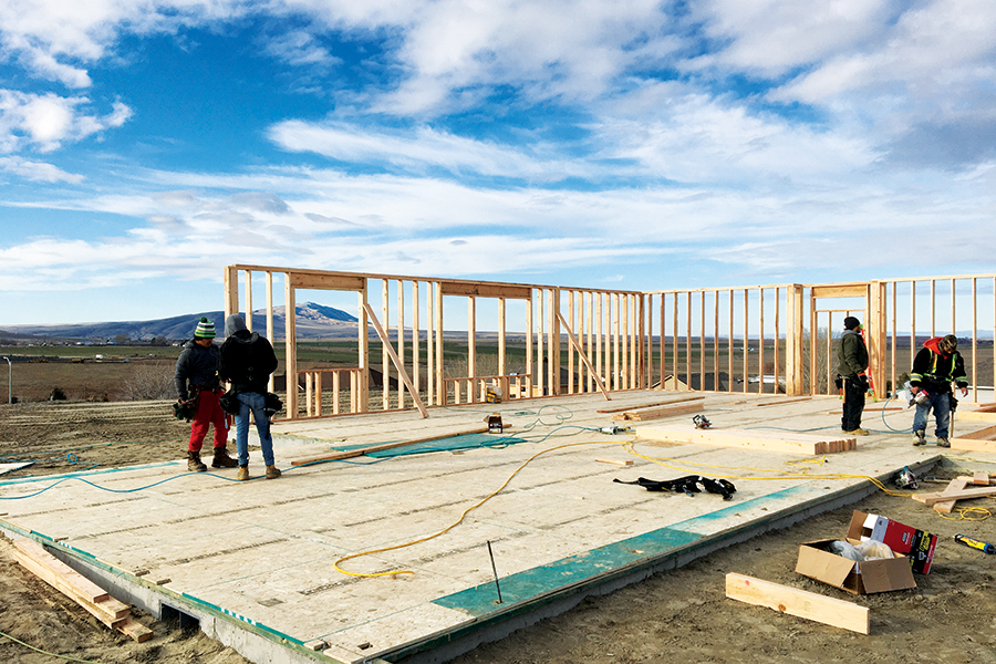 The window of a home under construction on Thebes Street in West Richland frames a view of Red Mountain. (Photo by Kristina Lord)