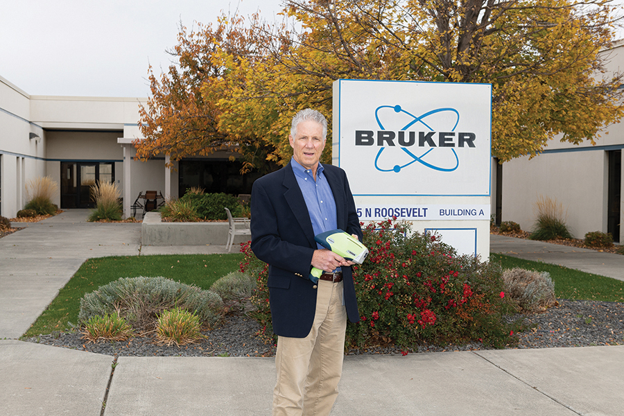 John Landefeld, executive vice president and managing director, Bruker Inc., holds a device that provides instant analysis of the elemental content of whatever it is pointed at: machine parts, scrap metal, marine oil, consumer products, soils, archaeological material and even fine art. Bruker is closing its Kennewick business as part of a global reorganization, and Landefeld hopes to help his staff find jobs elsewhere. (Courtesy Bruker Inc.)