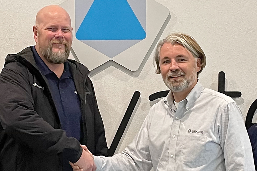 Mark Gloy, left, general manager of Executech Spokane, shakes hands with Paul Carlisle, general manager of Executech Tri-Cities. (Photo by Robin Wojtanik)