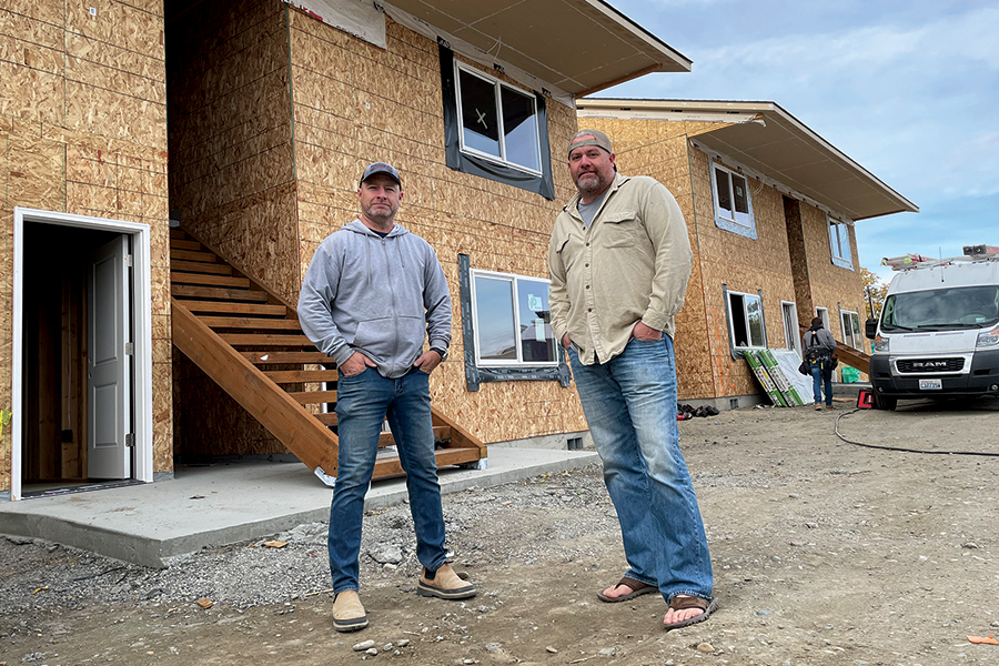 Colton Brady, left, and Britt Creer of Urban Range LLC stand outside their new fourplex development off Van Giesen Street, behind the West Richland police station. (Photo by Kristina Lord)