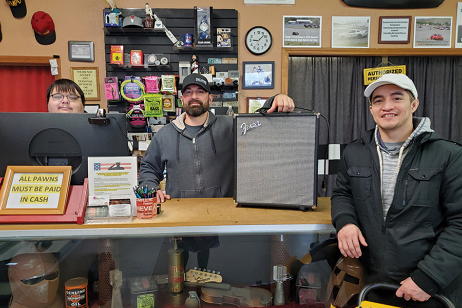 Ed and Moe’s Pawn Shop & Guitar Bar owner Russel Del Gesso, center, and employees Jay Valdez, left, and Lalo Ruiz, right, don’t run your average pawn shop. Not pictured is Joby Tijerina. Their passion is for musical equipment. The shop is at 419 W. Entiat Ave., Suite C, in Kennewick. (Photo by Laura Kostad)